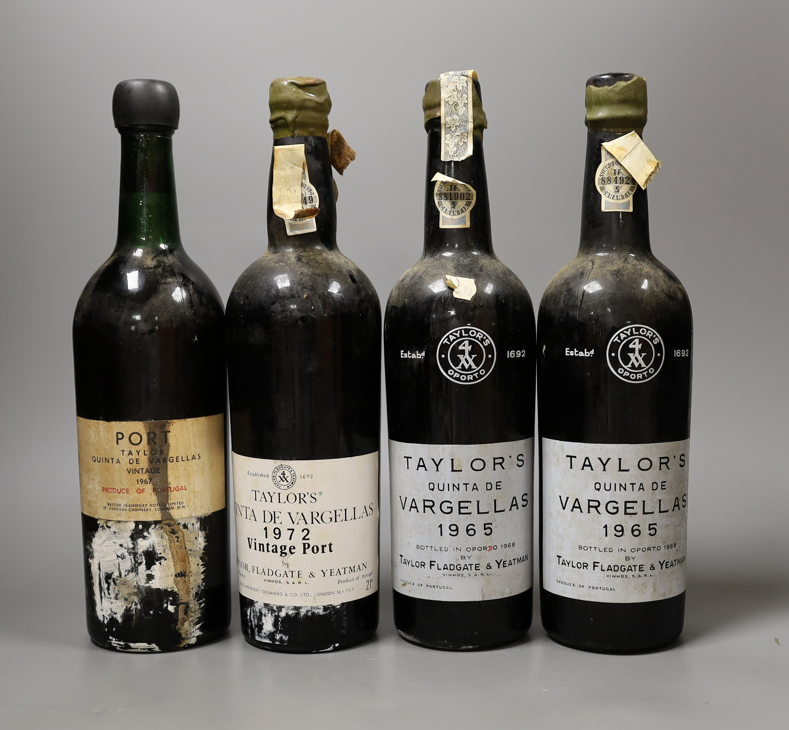 A four bottles of Taylor’s Quinta De Vargellas vintage port, two bottles dated 1965, one dated 1967 and the other 1972